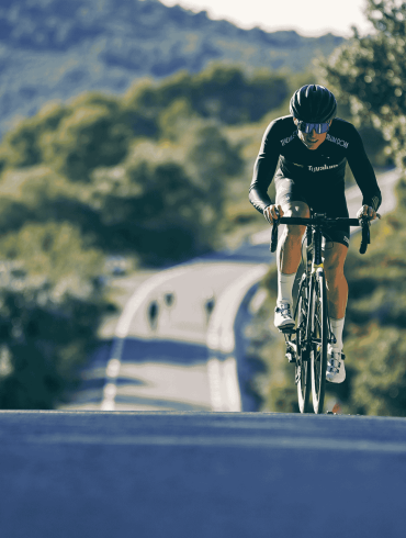 Cyclist Riding Road Bike on Hill