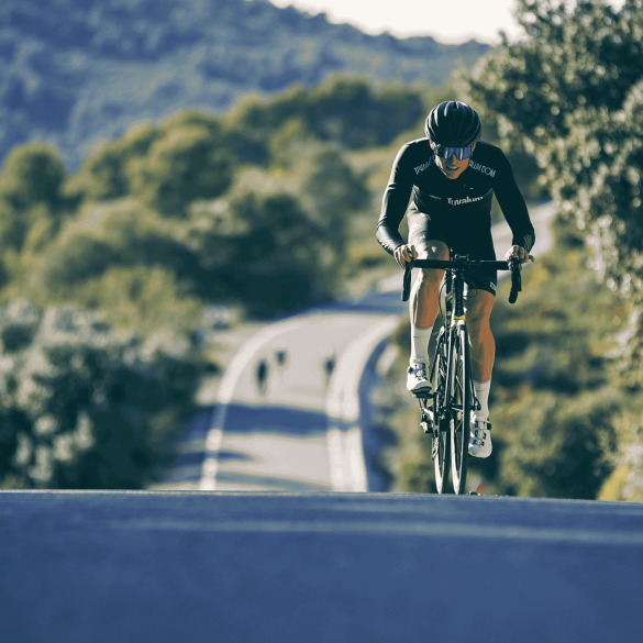 Cyclist Riding Road Bike on Hill
