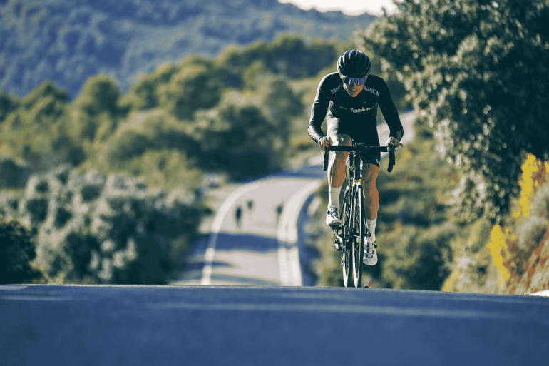 Cyclist Riding Road Bike on Hill