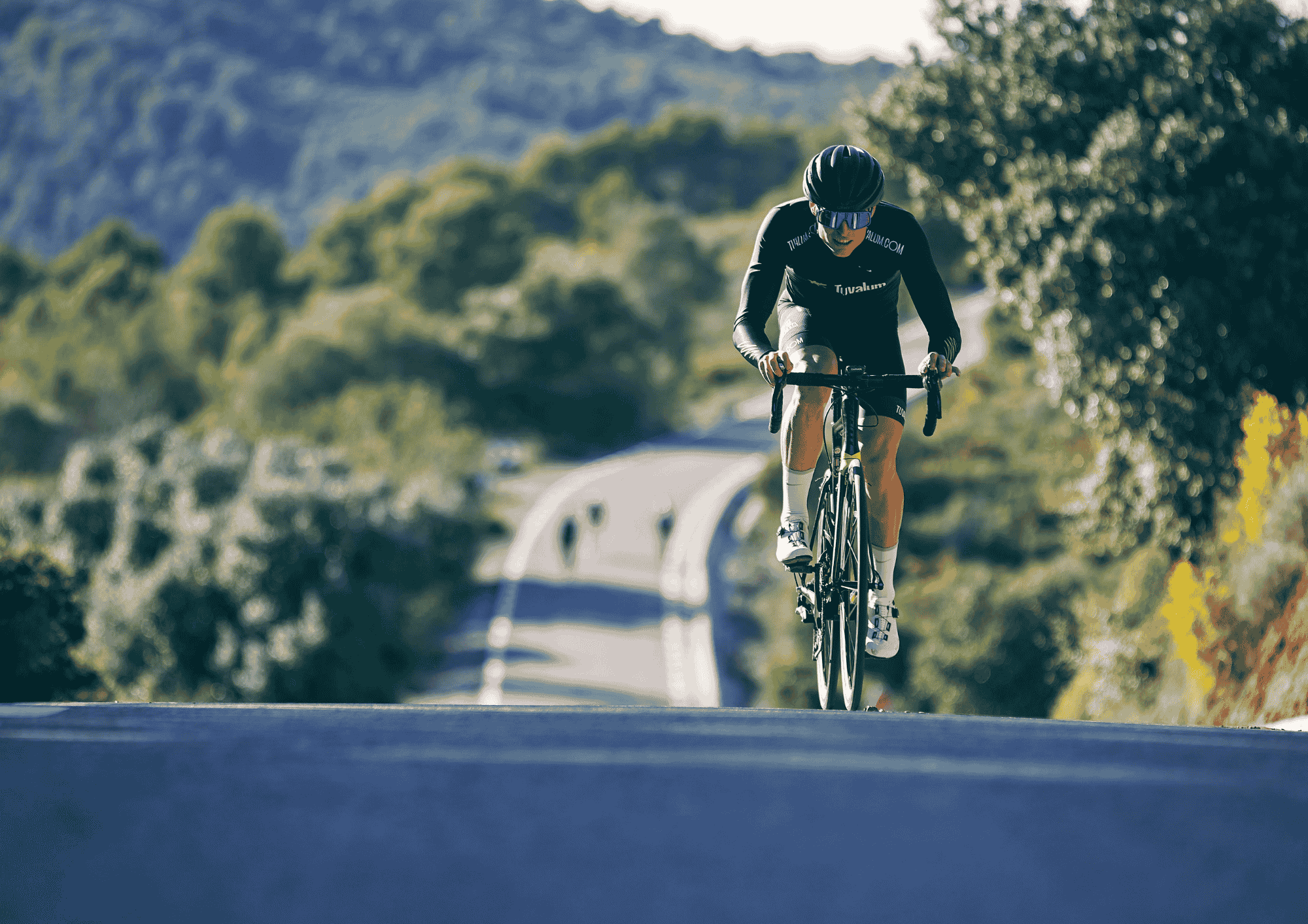 Cyclist Riding Road Bike on Hill